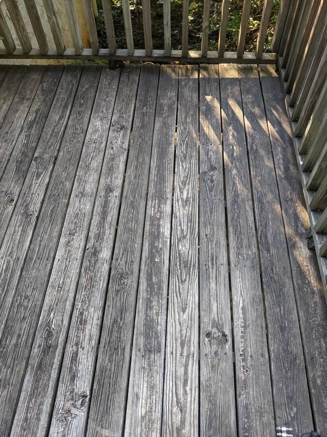 Weathered grey wood deck before restoration cleaning