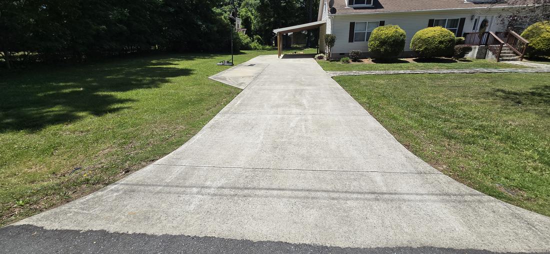 Stained concrete driveway before pressure washing